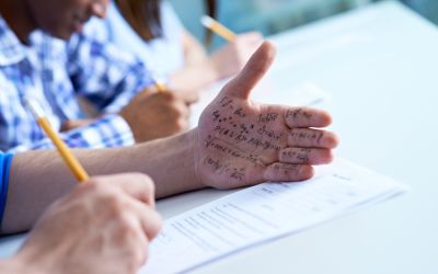 Photo of a test takers with cheat notes written on his hand, to illustrate the article What Does the Bible Say About Honesty and Integrity?